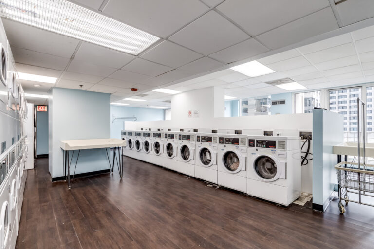 Modern laundromat interior with rows of washers in Early