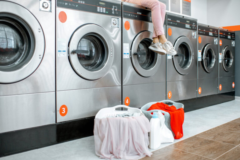 Row of modern washers and laundry baskets at Wash Em Up Odessa