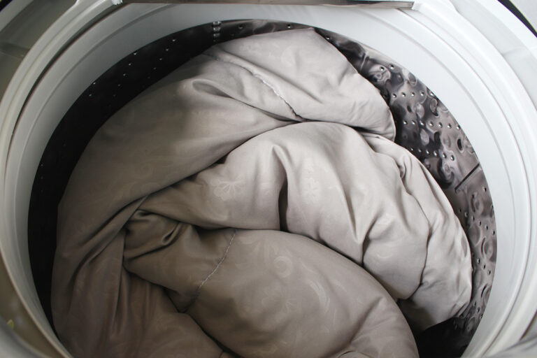 Comforter being washed in large washer at Odessa laundromat